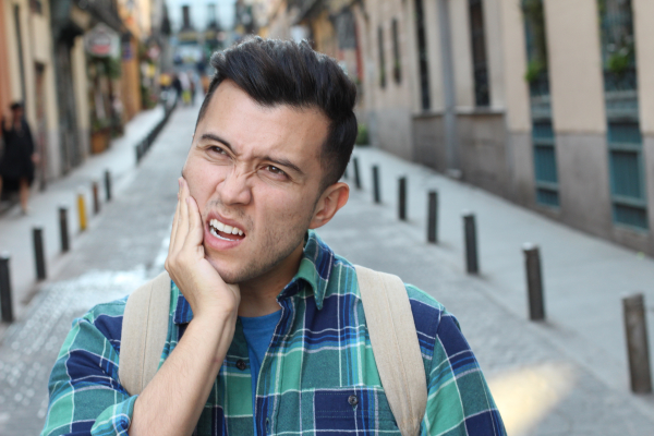 man feeling pain from awake bruxism